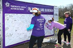 Participants signing the memory wall at the 2014 PurpleStride Chicago event. 
