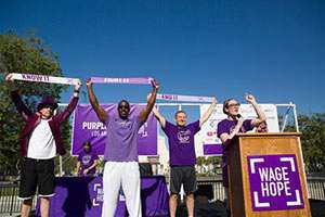 (From left to right) Dr. Nicholas Nissen, Michael Downs and Dr. Rick Selby take part in the PurpleStride Los Angeles ribbon ceremony accompanied by event emcee, Lisa Kennedy Montgomery.