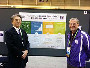 Yoshi Majima of Pancreatic Cancer Action Network Japan with Cincinnati volunteer Maurice Bason at Bason’s poster during the Scientist – Survivor Program.