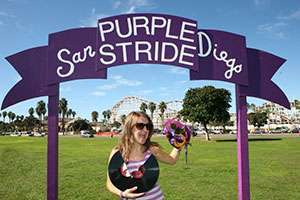Shanle symbolically “breaks a record” at PurpleStride San Diego when her volunteer-led team surpasses the previous year in fundraising and participants.