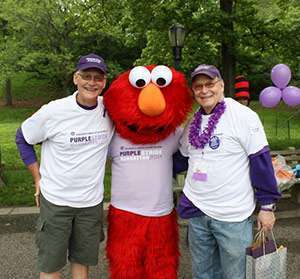 Ralph Cheney (right) and Michael Weinstein flank special guest Elmo at PurpleStride New York City in 2011.