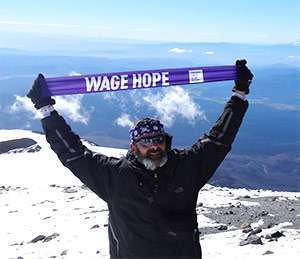 Joe Heiden stands atop Mount Adams in Oregon, at 12,280 feet, to Wage Hope two years after his pancreatic cancer diagnosis.