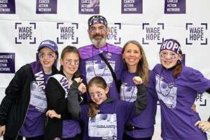 Joe with his wife, Amy, and their four daughters at PurpleStride. 