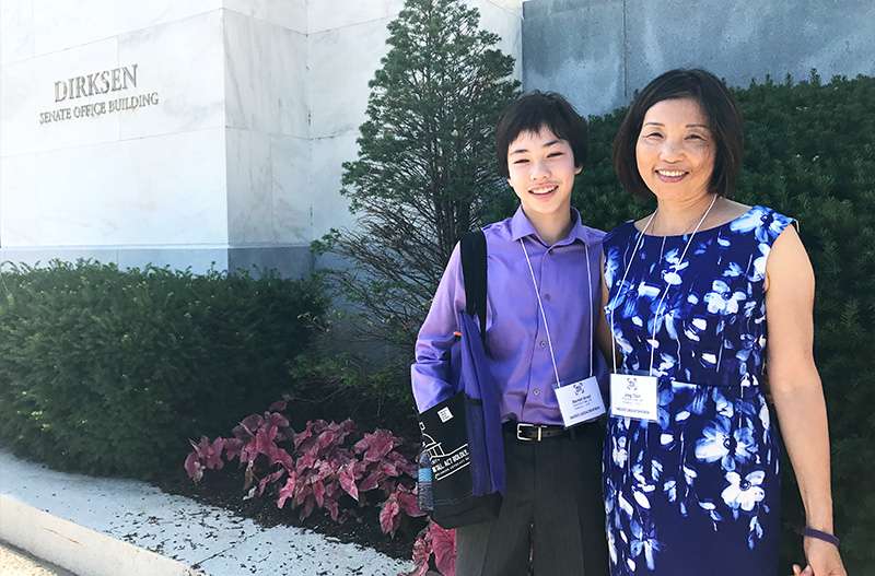 Teen embraces his mom outside of the Dirksen Senate Office Building before meeting with U.S. senators about pancreatic cancer