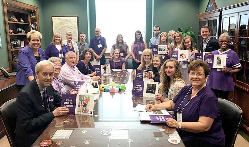 Large group of men and women from North Carolina smile after an advocacy meeting in a congressional office on Capitol Hill