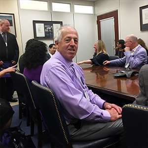 Pancreatic cancer survivor Bruce Hill sits in congressional meeting with other advocates during Advocacy Day on Capitol Hill.