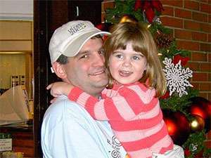 Nikki Cronin as a child hugging her dad, Dennis, who is now a seven-year pancreatic cancer survivor.