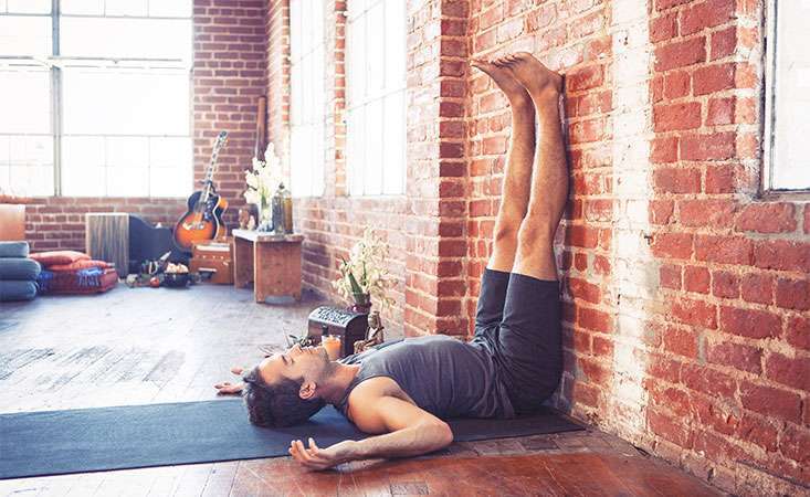 Yoga posture with legs up on a wall can aid in lymphatic drainage and generate energy