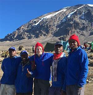 Ken Brown (middle) shares a photo with Tanzanian locals.