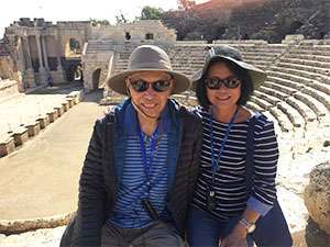 Hector and his wife take a photo at a landmark in Jordan during their travels