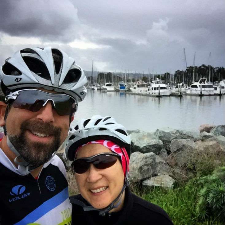 Long-term pancreatic cancer survivor and her husband wear bike helmets as part of her exercise
