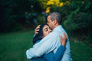 A pancreatic cancer patient and his wife hug after a difficult conversation.