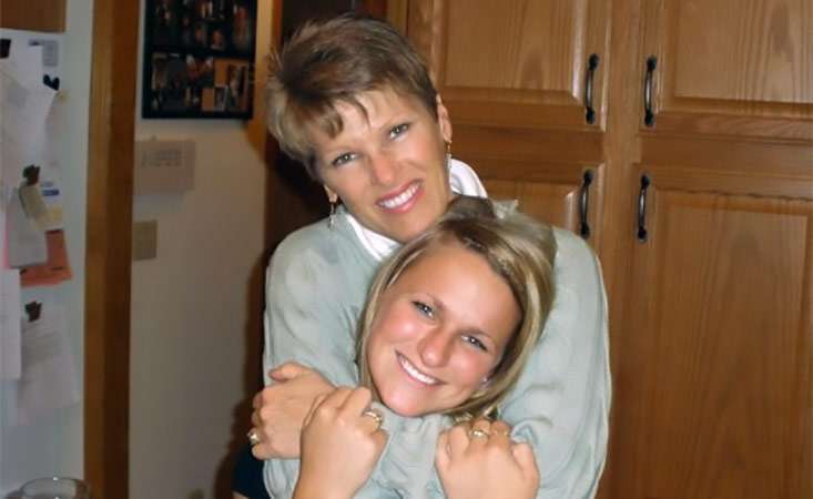 Mother with pancreatic cancer embracing her daughter who took care of her