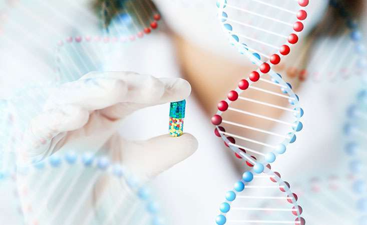 Scientist holds a pill next to image of DNA, representing molecularly targeted cancer treatment