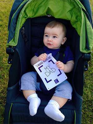 Baby boy holds “I Wage Hope for My Dad” sign at pancreatic cancer walk/run fundraiser 