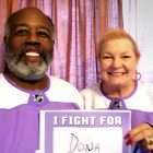 Husband and wife wearing Hockey Fights Cancer jerseys as she battles pancreatic cancer