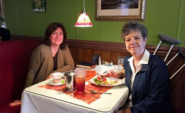Pancreatic neuroendocrine tumor survivor enjoys dinner at a restaurant with a friend