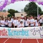 High school student at teen cancer fundraising walk with her coach, a cancer survivor