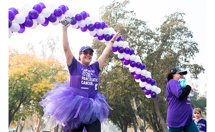 PurpleStride participant crosses finish line at the Sacramento walk to end pancreatic cancer