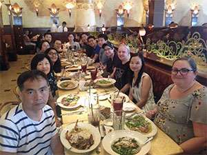 A group of pancreatic cancer researchers from the same lab at a restaurant