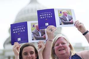 Mom and daughter show photo at Capitol building of family member who died of pancreatic cancer