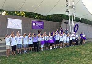 Pancreatic cancer survivors raise their hands together at Cincinnati walk to raise funds