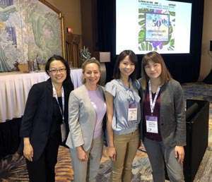 Three pancreatic cancer researchers with PanCAN CEO Julie Fleshman at scientific conference 