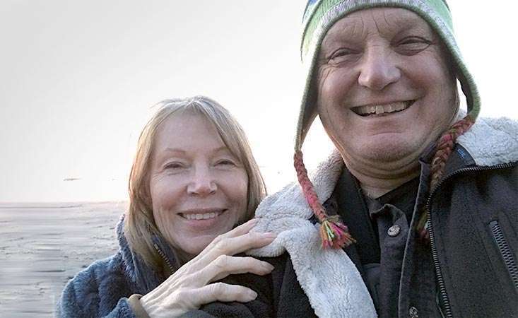 Stage 4 pancreatic cancer survivor smiling with her husband and caregiver