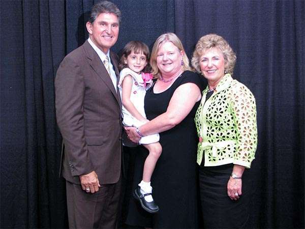 PanCAN volunteer in 2009, holding now grown daughter, when she received volunteer service award
