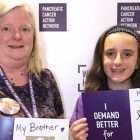 Mom and daughter hold photos of family member who inspired their pancreatic cancer volunteerism