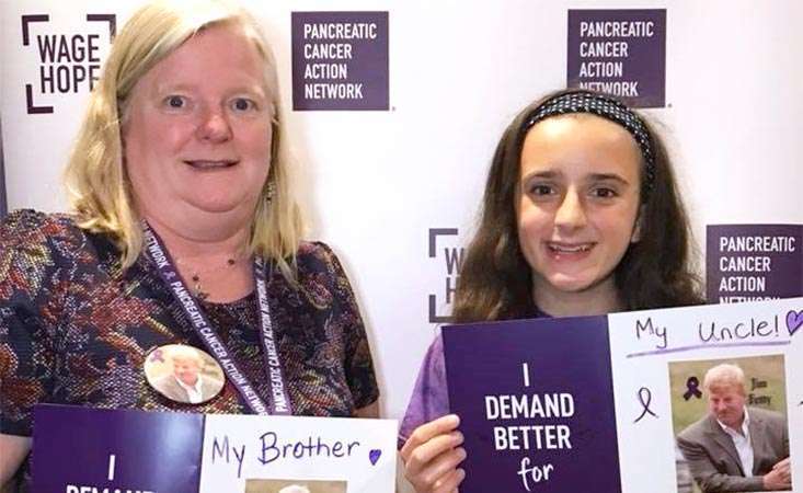 Mom and daughter hold photos of family member who inspired their pancreatic cancer volunteerism