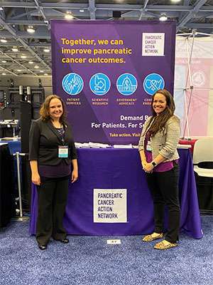 Pancreatic cancer patient advocacy staff in front of PanCAN exhibit booth at major conference