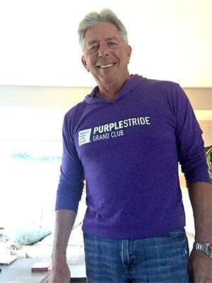 Fundraiser wearing PurpleStride t-shirt in honor of his sister who died of pancreatic cancer