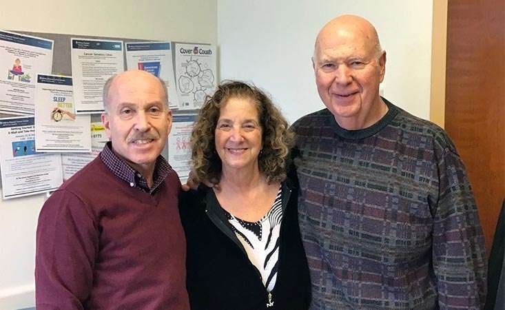 Two pancreatic cancer survivors and a caregiver in healthcare specialist’s office