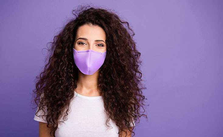 Woman wears face mask to keep pancreatic cancer patients safe from the coronavirus