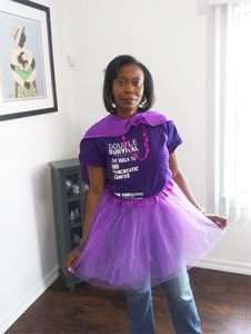 Volunteer decked out in purple, including a tutu and cape, for virtual PurpleStride to raise awareness of pancreatic cancer