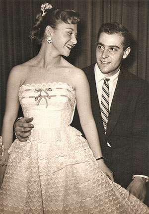 Young woman and man formally dressed for a graduation in the 1950s.