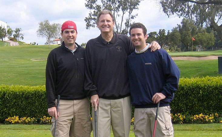 Dad and two adult sons golfing