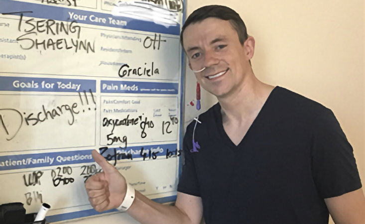 Hospital patient about to be discharged, standing by white board