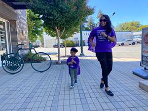 Woman and toddler walking in support of pancreatic cancer research.
