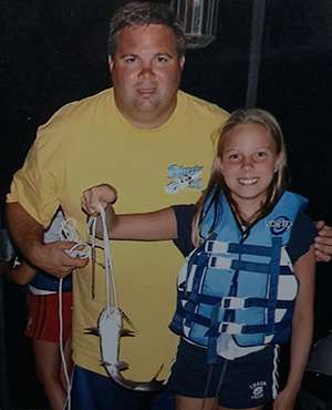 Young Melissa fishing with her father