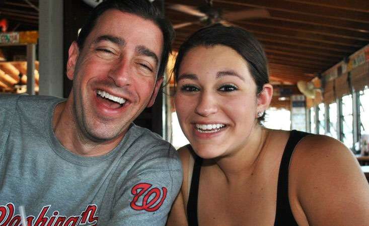 Father and daughter posing at a restaurant.