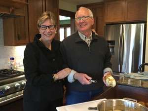 Renowned pancreatic cancer oncologist with her husband relax in the kitchen 