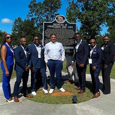Teen advocate Tybre Faw, center, with the John R. Lewis family in Troy, Ala. 