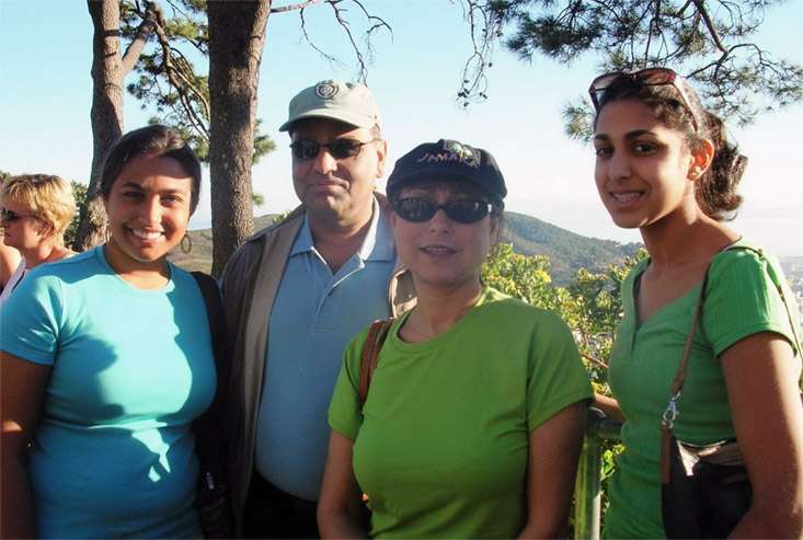 The Mukherjee family from left to right: Daughter Paula, Dad Sanjib, Mom Mausumi, and Daughter Elina posing for photo in Cape Town, South Africa.