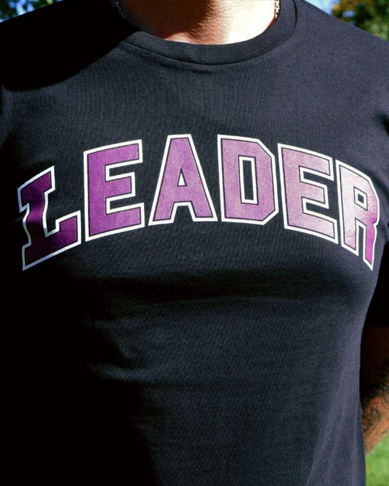 Close up of a T-shirt with the word LEADER on it worn by a man.