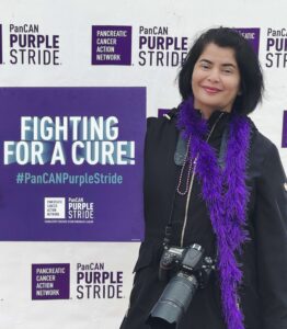 PanCAN volunteer Monica Mishri holding a “Fighting for a Cure!” sign.
